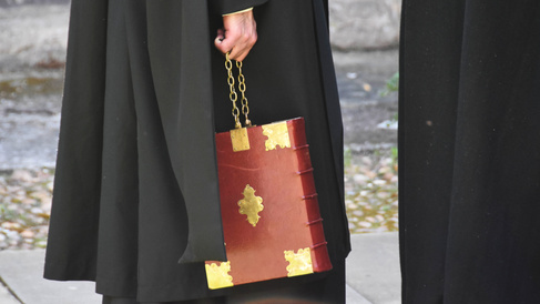 Proctor carrying ceremonial chained copy of the University Statutes